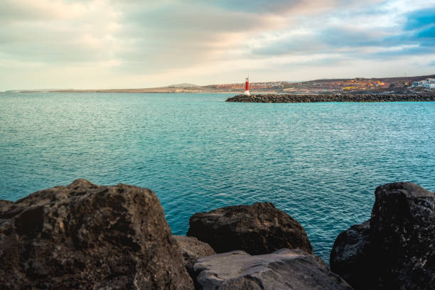 A scenic view of a blue ocean on a cloudy sky background