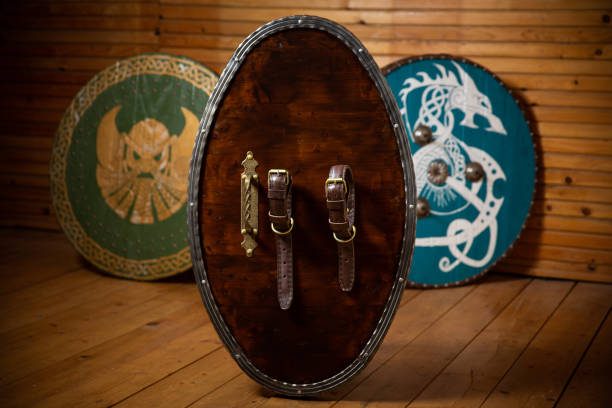 istock Three wooden medieval shields in a room 1454335239