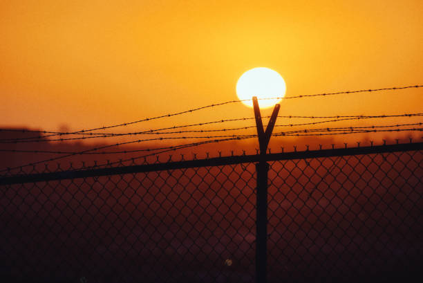 istock Fascinating colorful sunset and a fence 1454338059