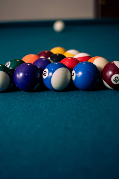 istock Vertical shot of colored billiard balls on a pool table 1454338135