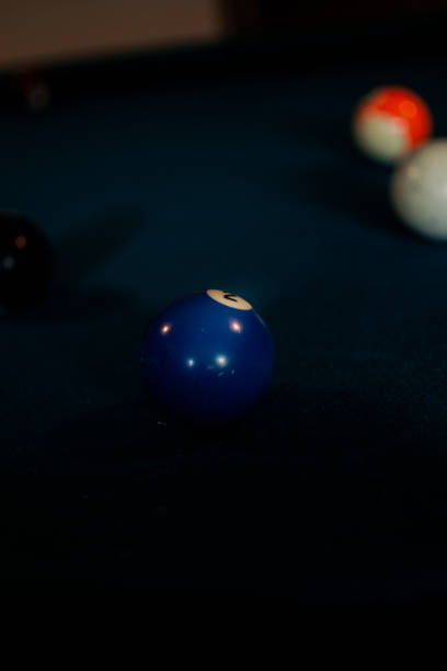 istock Vertical shot of a blue billiard ball on a pool table 1454338138