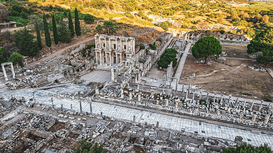 Ephesus (Éphesos; Turkish: Efes) was a city in ancient Greece on the coast of Ionia, 3 kilometres (1.9 mi) southwest of present-day Selçuk in İzmir Province, Turkey. It was built in the 10th century BC on the site of the former Arzawan capital by Attic and Ionian Greek colonists. During the Classical Greek era, it was one of twelve cities that were members of the Ionian League. The city came under the control of the Roman Republic in 129 BC.\n\nThe city was famous in its day for the nearby Temple of Artemis (completed around 550 BC), which has been designated one of the Seven Wonders of the Ancient World. Its many monumental buildings included the Library of Celsus and a theatre capable of holding 24,000 spectators.\n\nEphesus was recipient city of one of the Pauline epistles; one of the seven churches of Asia addressed in the Book of Revelation; the Gospel of John may have been written there; and it was the site of several 5th-century Christian Councils (see Council of Ephesus). The city was destroyed by the Goths in 263. Although it was afterwards rebuilt, its importance as a commercial centre declined as the harbour was slowly silted up by the Küçükmenderes River. In 614, it was partially destroyed by an earthquake.\n\nToday, the ruins of Ephesus are a favourite international and local tourist attraction, being accessible from Adnan Menderes Airport and from the resort town Kuşadası. In 2015, the ruins were designated a UNESCO World Heritage Site.