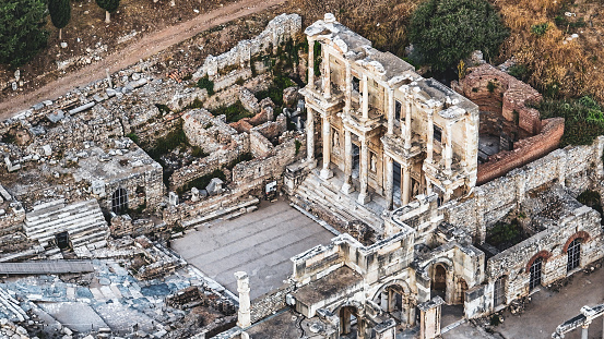 Ephesus (Éphesos; Turkish: Efes) was a city in ancient Greece on the coast of Ionia, 3 kilometres (1.9 mi) southwest of present-day Selçuk in İzmir Province, Turkey. It was built in the 10th century BC on the site of the former Arzawan capital by Attic and Ionian Greek colonists. During the Classical Greek era, it was one of twelve cities that were members of the Ionian League. The city came under the control of the Roman Republic in 129 BC.\n\nThe city was famous in its day for the nearby Temple of Artemis (completed around 550 BC), which has been designated one of the Seven Wonders of the Ancient World. Its many monumental buildings included the Library of Celsus and a theatre capable of holding 24,000 spectators.\n\nEphesus was recipient city of one of the Pauline epistles; one of the seven churches of Asia addressed in the Book of Revelation; the Gospel of John may have been written there; and it was the site of several 5th-century Christian Councils (see Council of Ephesus). The city was destroyed by the Goths in 263. Although it was afterwards rebuilt, its importance as a commercial centre declined as the harbour was slowly silted up by the Küçükmenderes River. In 614, it was partially destroyed by an earthquake.\n\nToday, the ruins of Ephesus are a favourite international and local tourist attraction, being accessible from Adnan Menderes Airport and from the resort town Kuşadası. In 2015, the ruins were designated a UNESCO World Heritage Site.