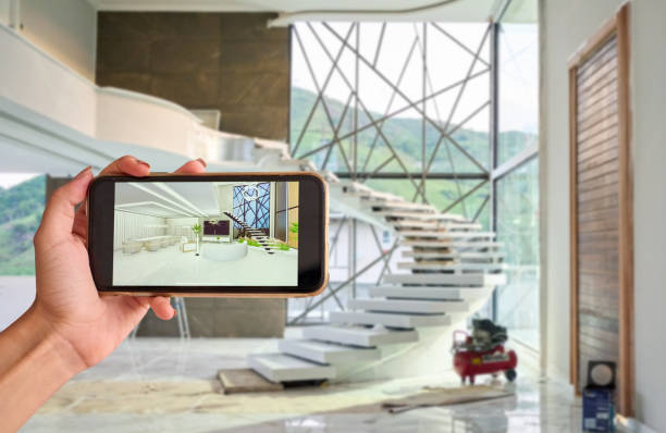 istock Architect's hand showing interior design renders on phone at construction site 1454342708