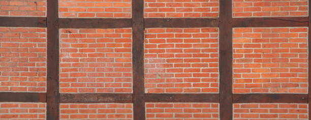 istock Stone wall made of bricks with wooden beams 1454343605