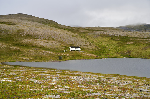 A beautiful view of a small white cottage on a highland, north of Norway