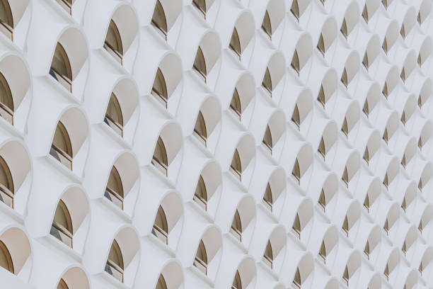 A closeup of a white building with modern windows