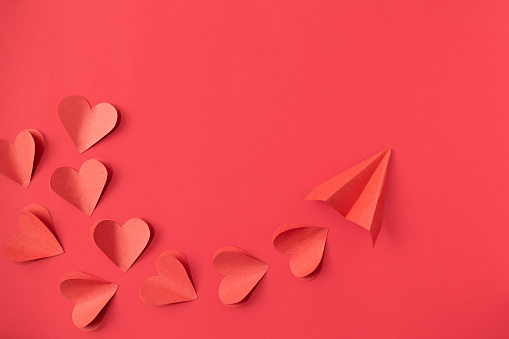Valentine's Day background with red hearts on red background with copy space