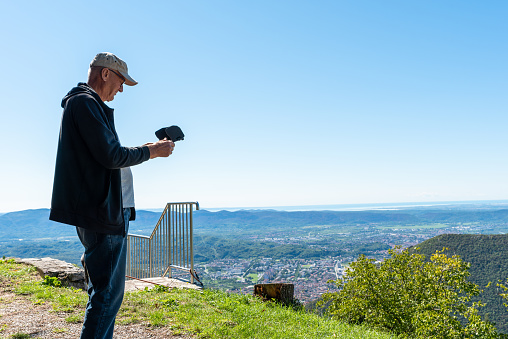 Man Using Remote Control Man Using Remote Control To Flying A Drone For Making Landscape Videos ...