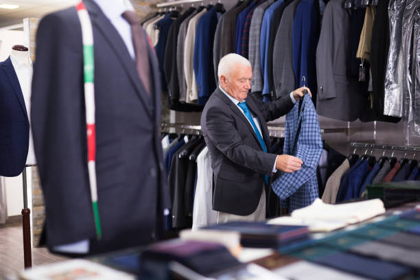 istock Mature customer looking jacket in men clothes store 1454346991