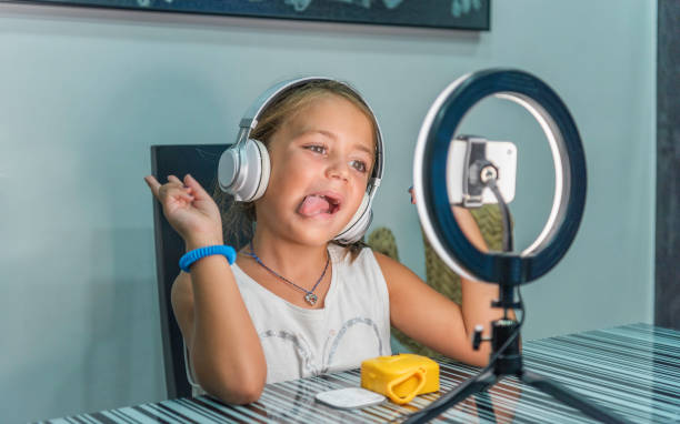istock Caucasian girl making faces while recording herself. 1454347014