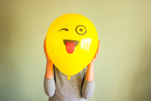 istock Child holding yellow balloon in the hands 1454347971