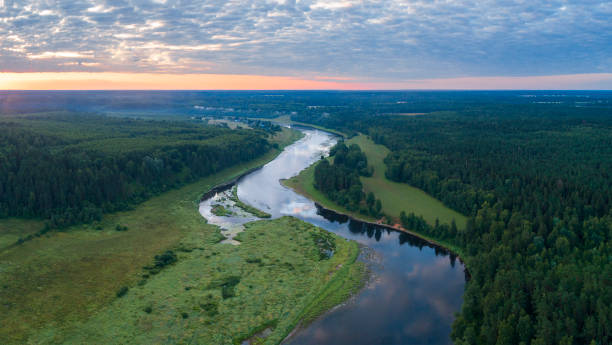 istock Aerial panoramic landscape with sunset over the river with islands and beautiful clouds on the sky. 1454348404