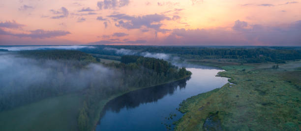 istock Aerial panoramic landscape with sunset over the river with islands and beautiful clouds on the sky. 1454350826