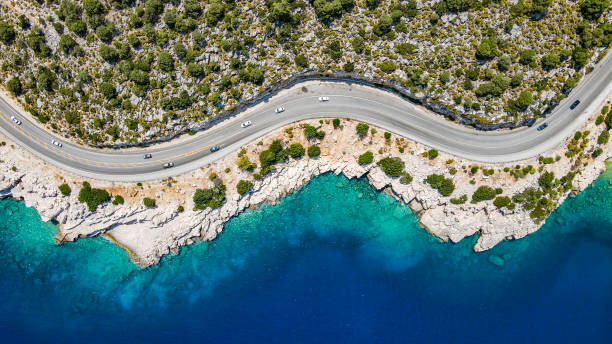 Aerial view of beach side road, aerial view of cliff side road, Aerial view of sloping and curvy road, background for vacation travel, most beautiful roads, beautiful road with scenery, finike,demre Aerial view of the road with beautiful view by the sea in Antalya Finike. Turkey coastline stock pictures, royalty-free photos & images