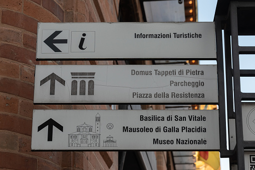Road sign for San Vitale basilica, parking, tourist information, National museum, Mausoleum of Galla Placidia,stone carpet domus and Piazza Resistenza