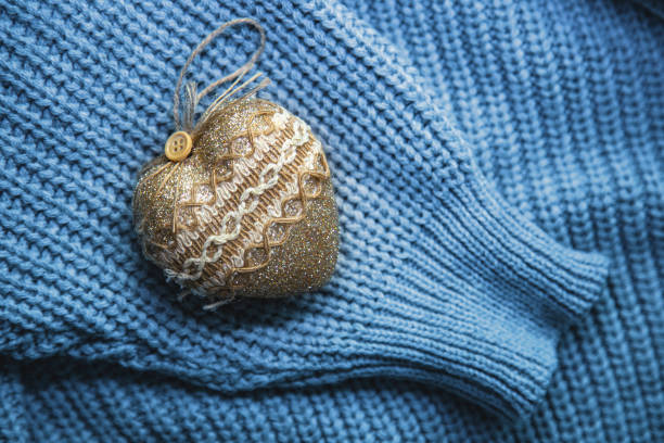 istock Blue texture knitted sweater with beige heart 1454358451