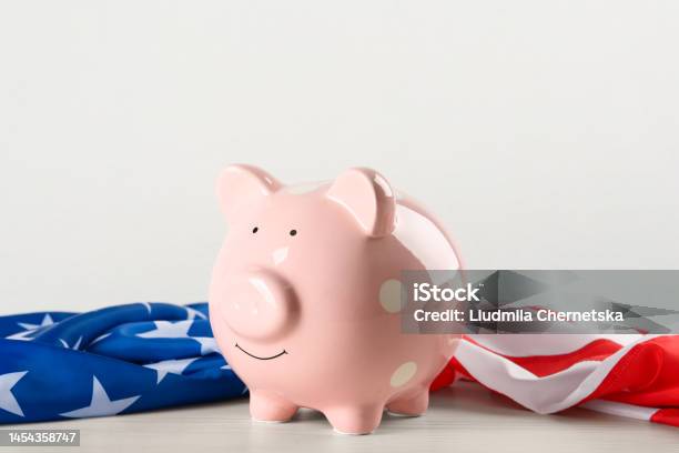 Piggy Bank And American Flag On White Wooden Table Stock Photo - Download Image Now - American Flag, Banking, Blue