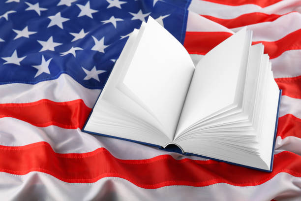 istock Open blank book on national American flag 1454358755