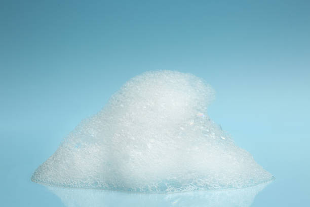 istock Drop of fluffy bath foam on turquoise background 1454359573