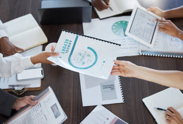 istock Business meeting, paperwork and team working on project in the office conference room. Teamwork, collaboration and group of people planning corporate company with documents strategy in the workplace. 1454359700