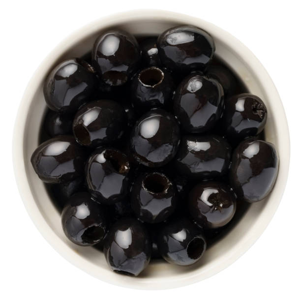 istock Delicious black olives in bowl isolated on white 1454360078
