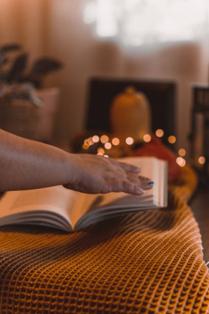 istock autumn photo on table with candles reading a book 1454360864