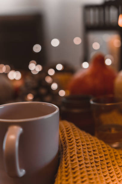istock autumn photo on table with candles drinking coffee 1454361200