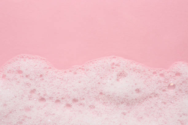 istock Fluffy bath foam on pink background, top view. Space for text 1454361982