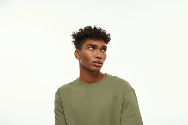 Focused african american handsome guy looking up