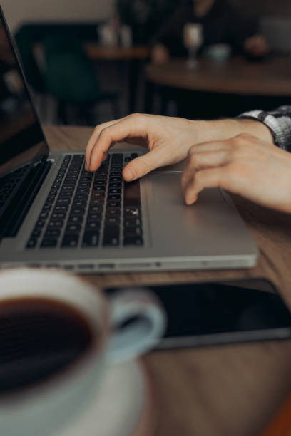 istock Digital nomad typing on laptop keyboard in cafe 1454363170