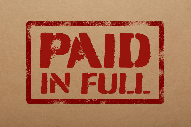 istock Kraft paper with stamp PAID IN FULL, top view 1454364150