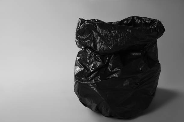 istock Trash bag full of garbage on grey background. Space for text 1454364391