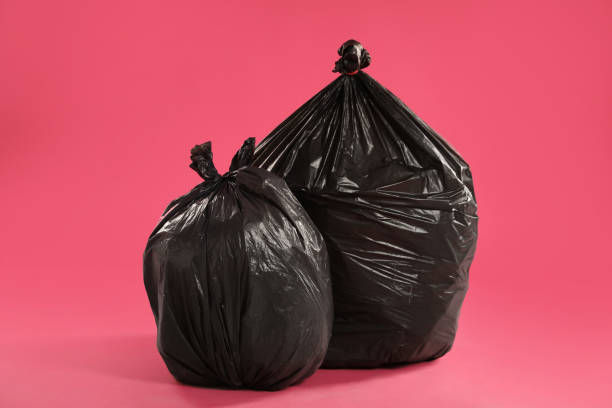 istock Trash bags full of garbage on pink background 1454364718