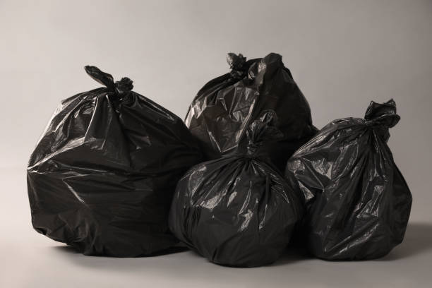 istock Trash bags full of garbage on grey background 1454364769