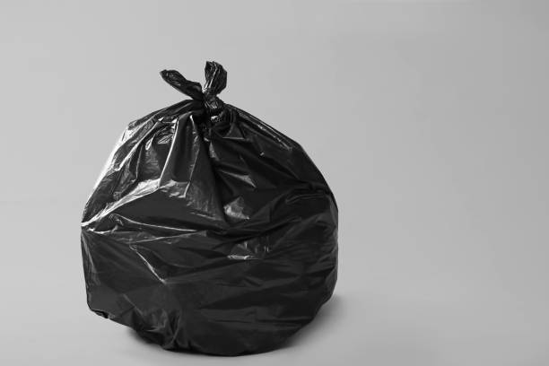 istock Trash bag full of garbage on grey background. Space for text 1454365125