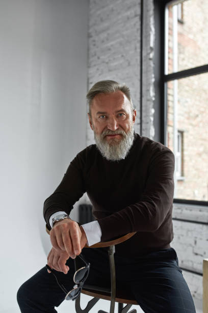 istock Elderly man sitting on chair in spacious apartment 1454366059