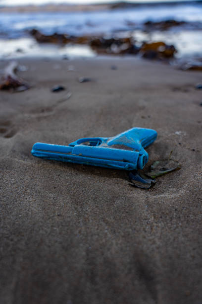 istock toy blue plastic gun on a sandy beach in north yorkshire, uk 1454367598