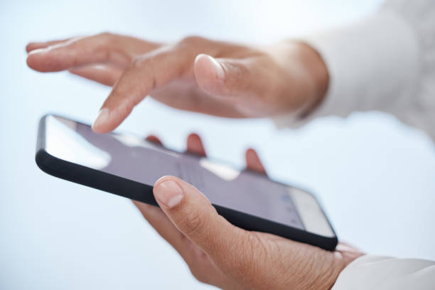 istock Businessman hands working with phone screen with in a office online on a mobile. Digital, internet and web app of a business planning a web email or strategy for a project, networking or text contact 1454368742