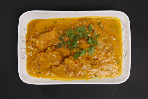 Chicken karahi bhuna korma masala with gravy served in karahi isolated on background top view of bangladeshi, indian and pakistani traditional spicy food