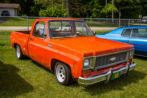 Iola, WI - July 07, 2022: High perspective front corner view of a 1974 Chevrolet C10 Pickup Truck at a local car show.