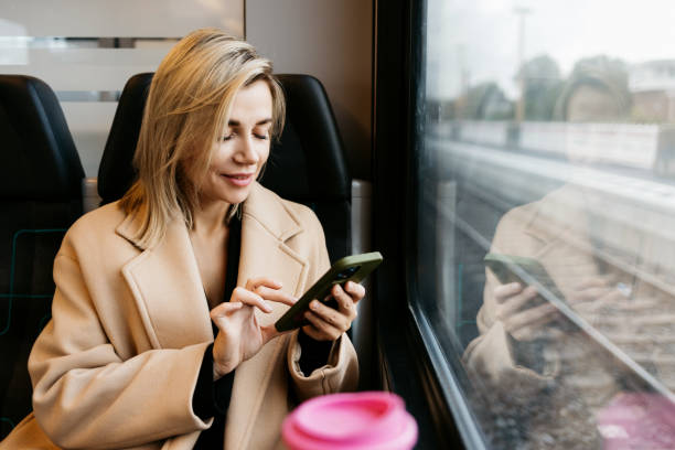 istock A young woman is talking on the phone in the train 1454371162