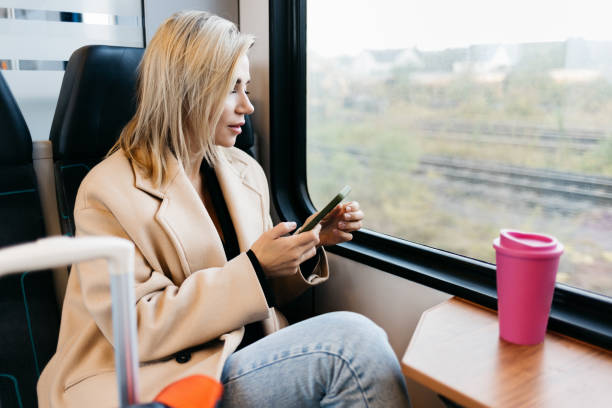 istock A young woman is talking on the phone in the train 1454371176