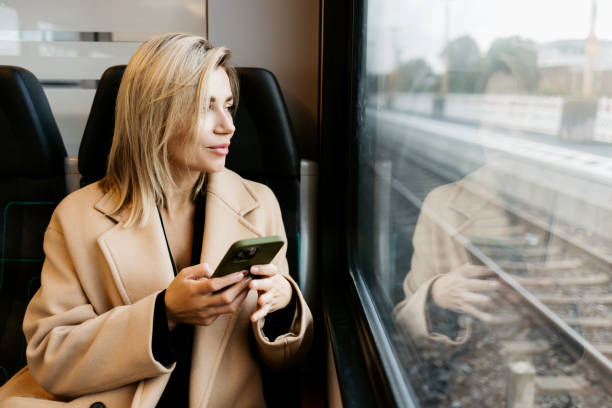 istock A young woman is talking on the phone in the train 1454371213