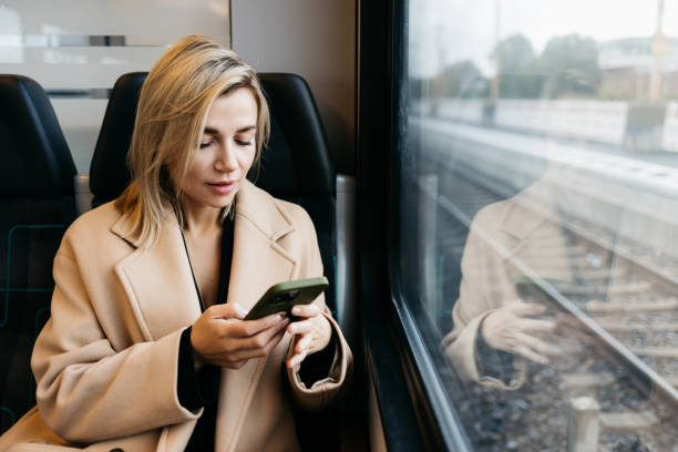 istock A young woman is talking on the phone in the train 1454371222