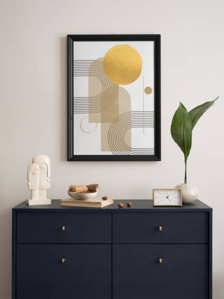 istock Interior design of harmozized living room interior with blue commode, mock up poster frame, leaves i vase, decoration and personal accessories. Modern home decor. Template. 1454372977