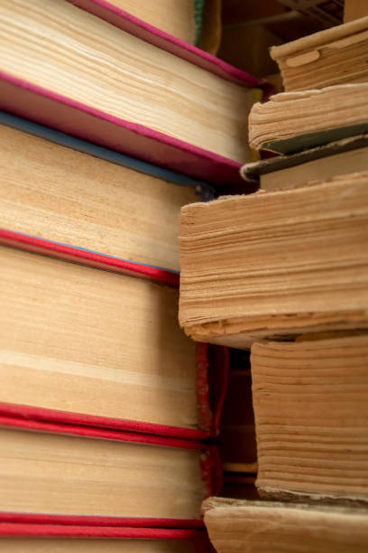 istock A stack of old books shooting up close. Old paper in books - a large stack - vertical photo. Ancient books in a stack. 1454373486