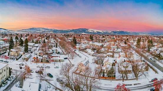 An aerial view of snow covered cityscape Missoula during sunset