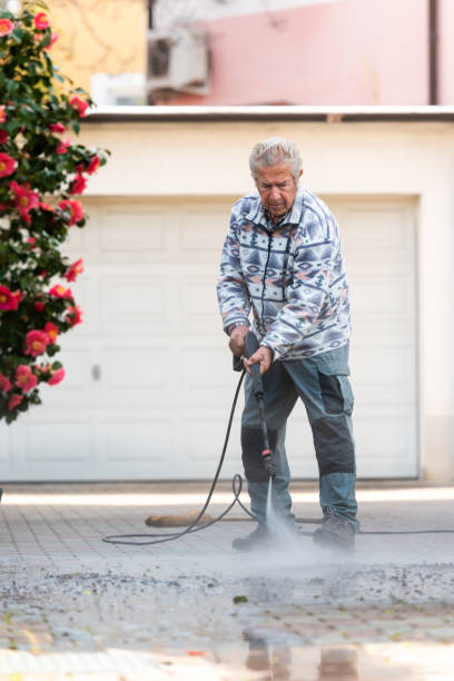 istock Active Senior Man in Spring Cleaning the Patio Using High Pressure Washer 1454374390