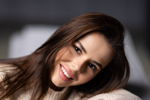 istock Happy young woman lying on couch and relaxing at home 1454374937